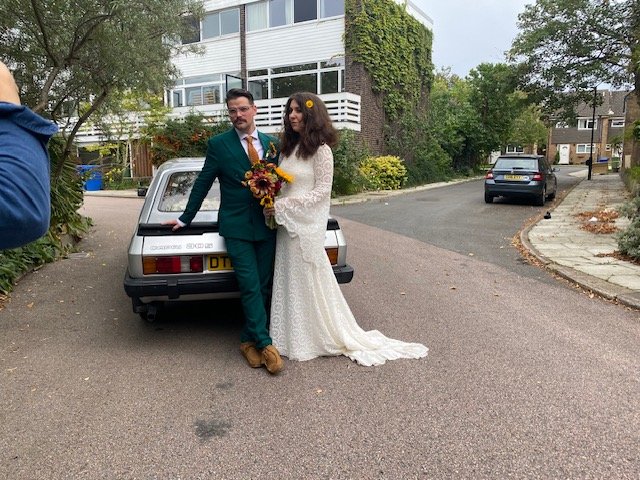 Bride and groom beside the silver Ford Capri 3.0 S