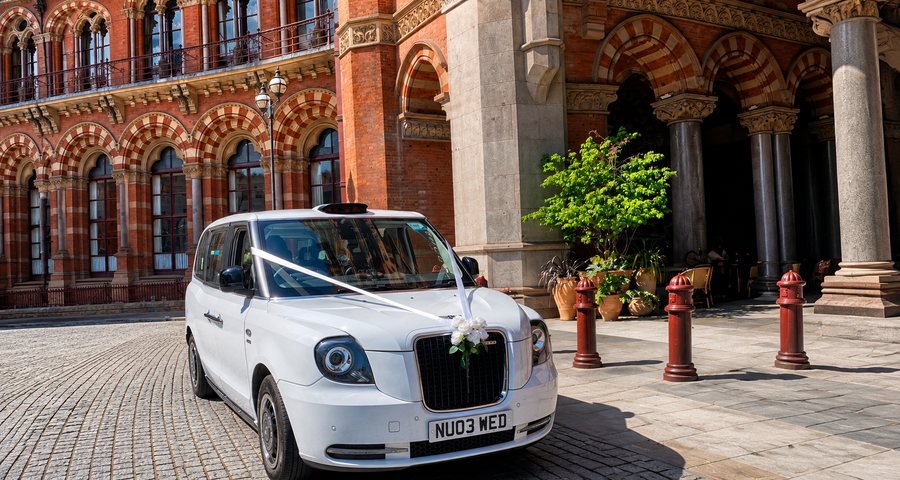 Electric TXE wedding taxi beneath the arches at St Pancras