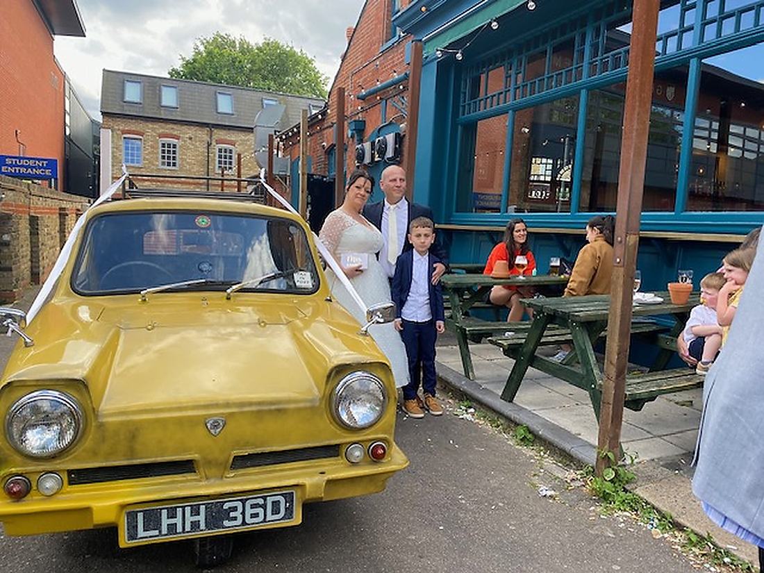 Wedding party gathered beside the Del Boy Trotter Van